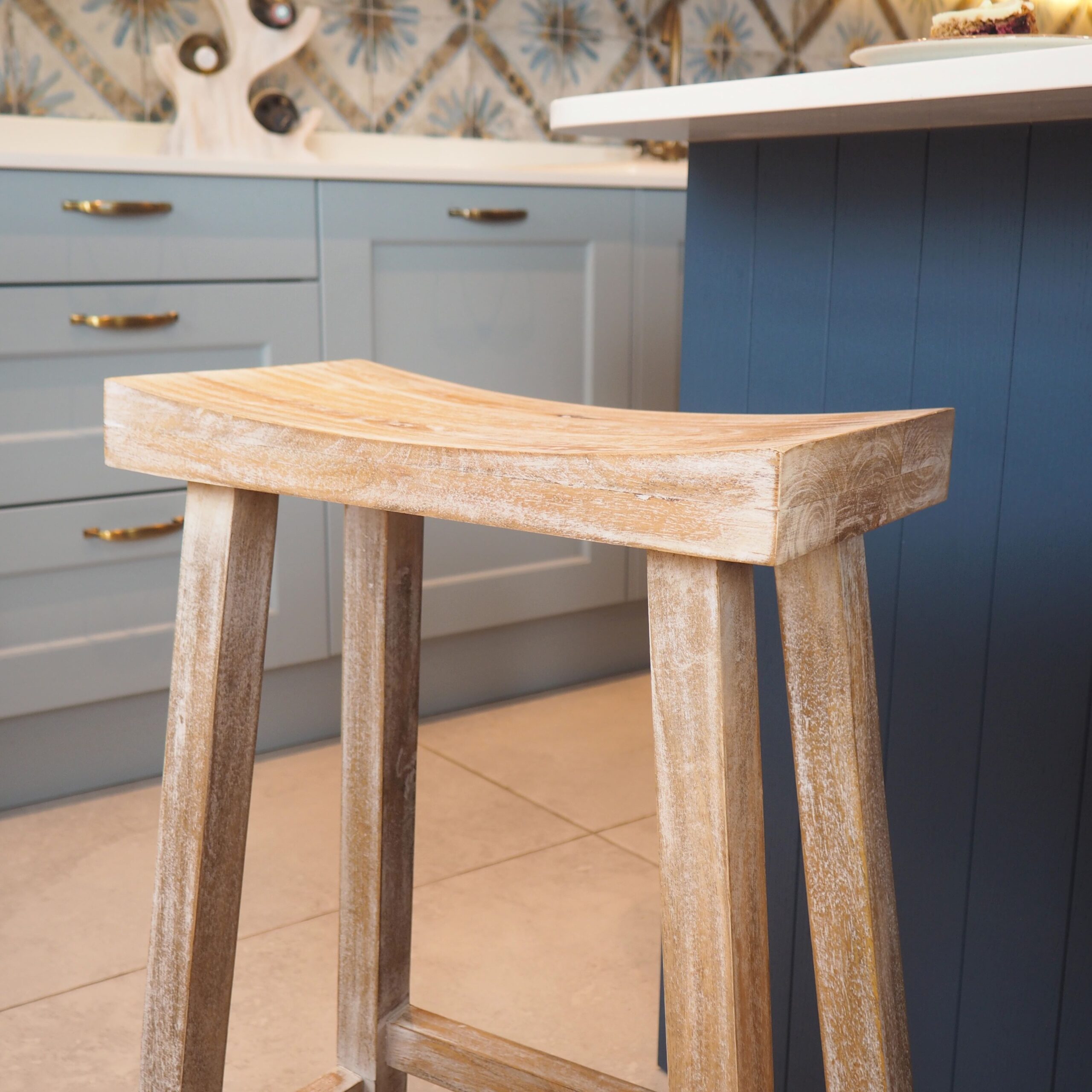 Close up of whitewashed bar stool in kitchen