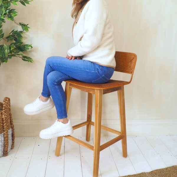 Girl sat on rattan kitchen stool