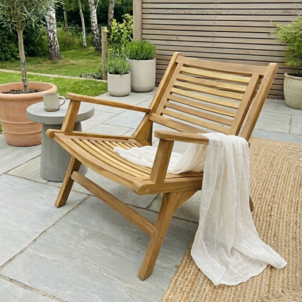 teak garden chair on concrete patio, with plants