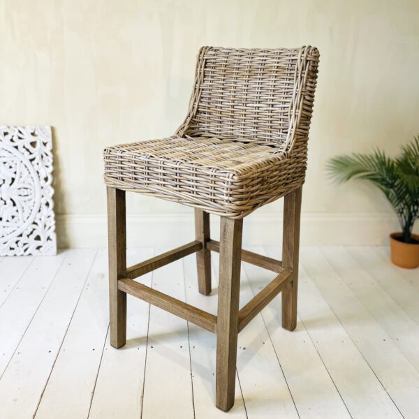 Wicker kitchen stool on white wooden floor