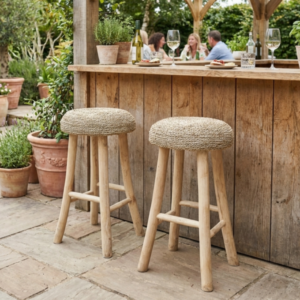 wicker bar stools at garden bar with people drinking in background