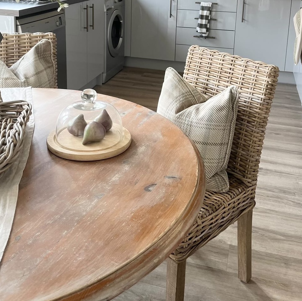 wicker dining chair at round kitchen table