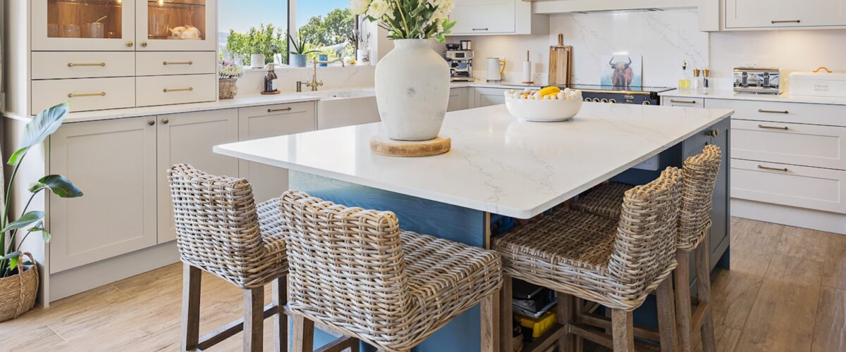 kitchen with granite island and wicker bar stools