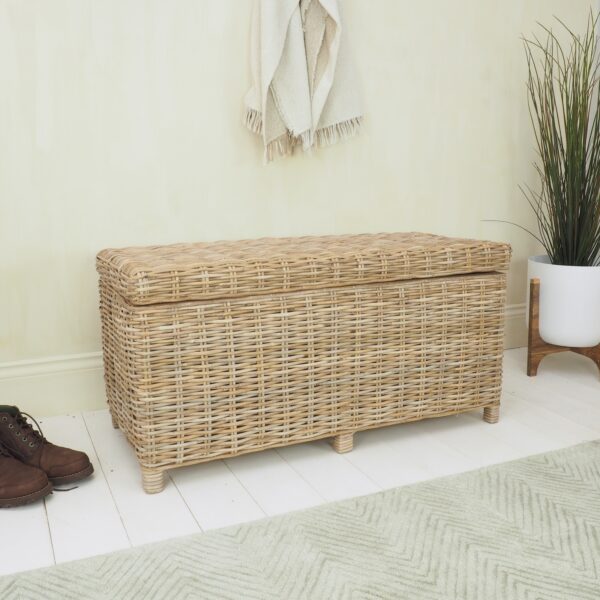 wicker storage trunk in hallway on white wood floor