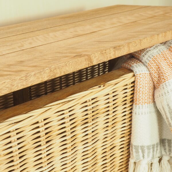detailed photo of wicker storage trunk and colourful throw