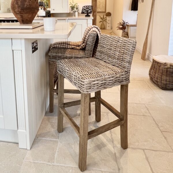 wicker bar stool in kitchen with stone floor