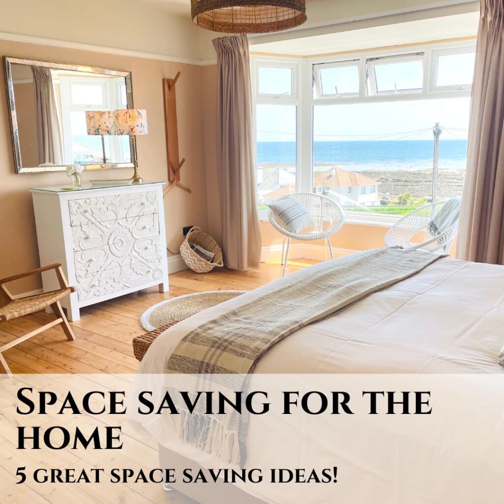 Space saving ideas, with a bedroom scene featuring a bed and white sideboard, a large mirror and bay window, on a wooden floor