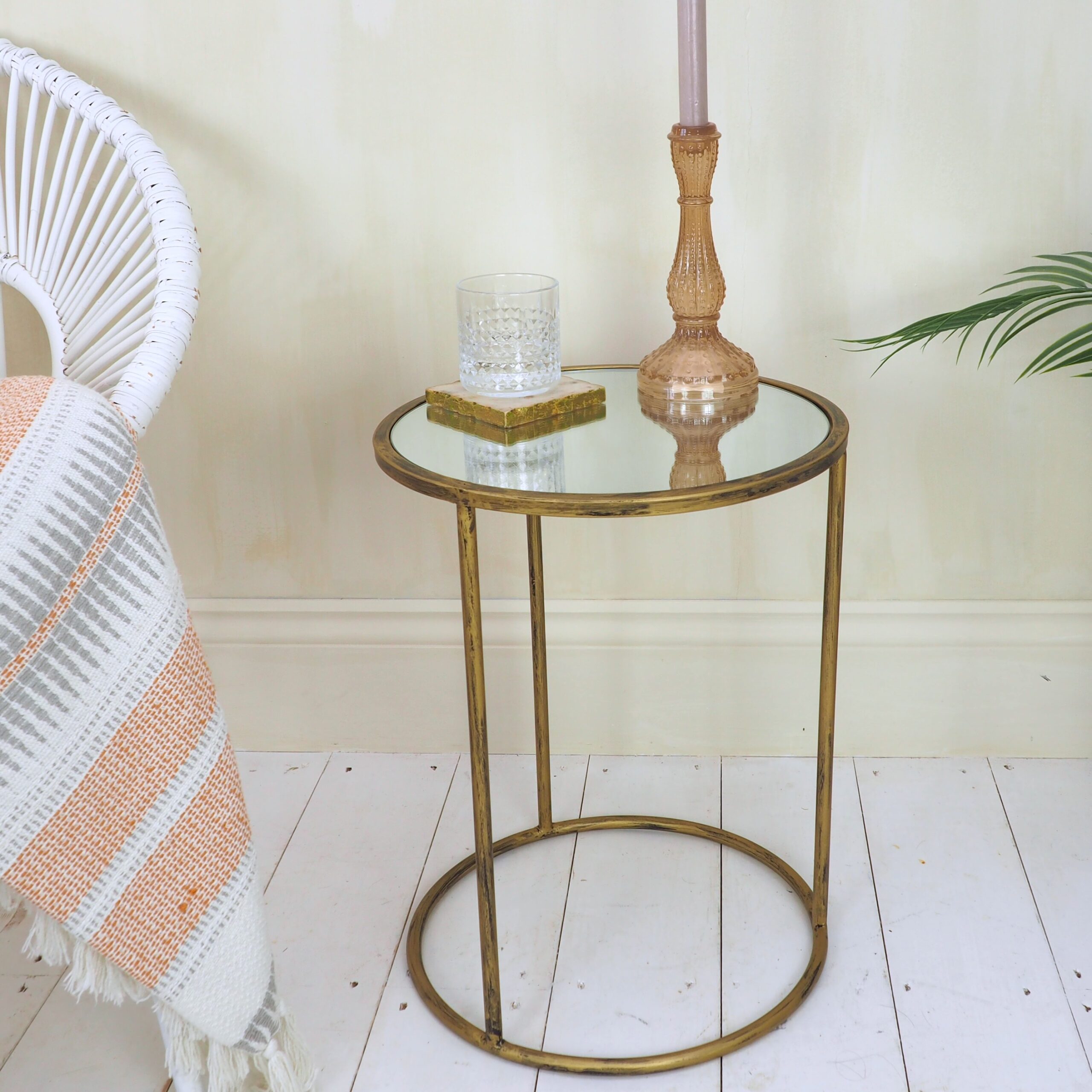 Small round brass side table with candlestick and glass