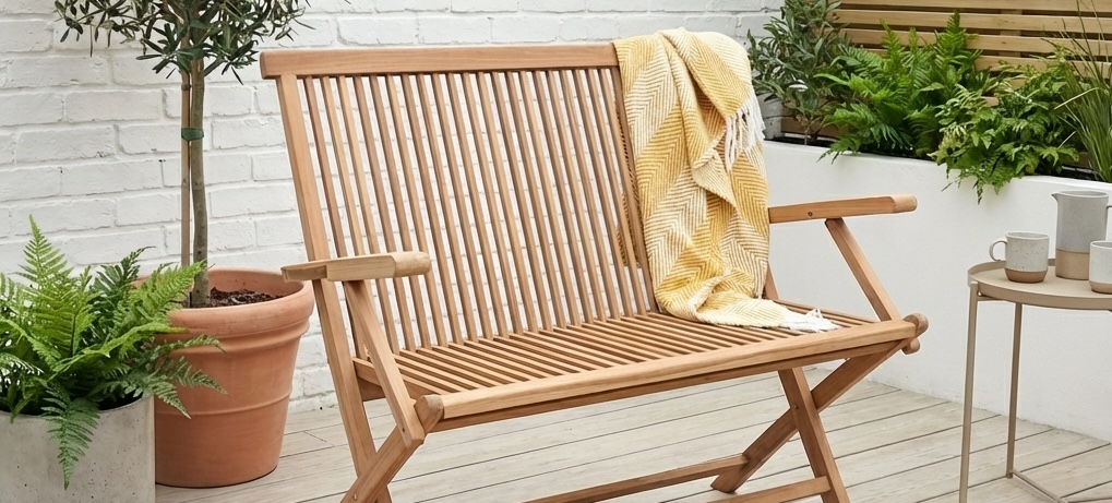 garden bench on outdoor decking with plants