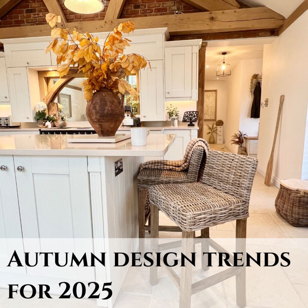 Autumn design trends inspired kitchen room with orange leave in a vase, and wicker furniture next to a kitchen island