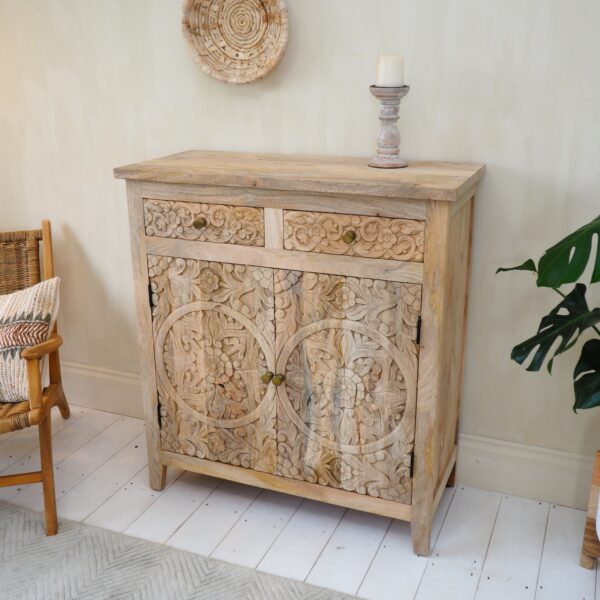 mango wood sideboard with armchair and plant